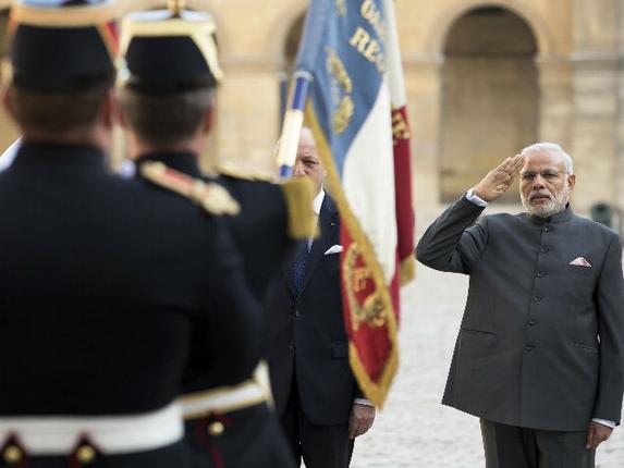 Prime Minister Narendra Modi salutes the French flag during a welcoming ceremony in the courtyard of the Hotel des Invalides in Paris, France.