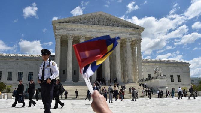 People cheer as the legal teams defending same-sex marriages leave the US Supreme Court