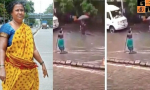 Mumbai woman stands in rain to warn of manhole.jpg